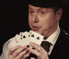 Peter as Charles Dickens showing four cards