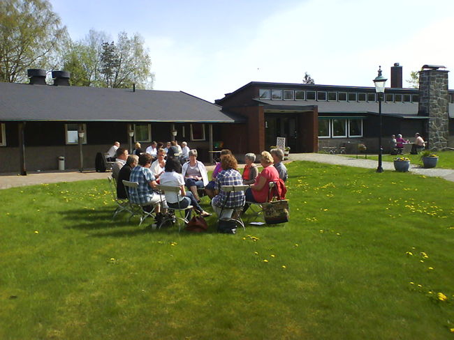 A group of participants in dialouge outdoors