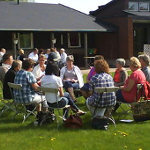 A group of participants in dialouge outdoors