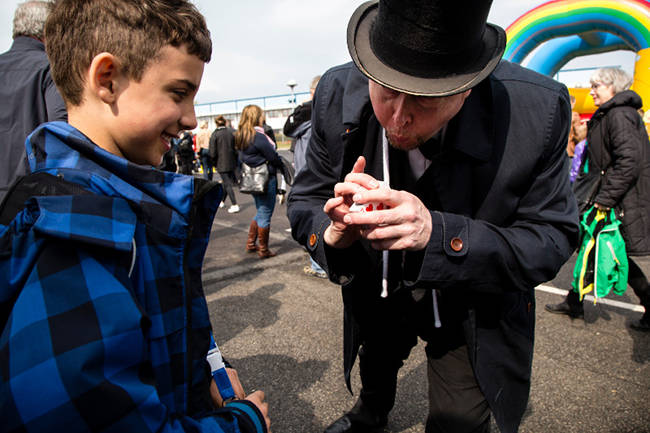 Peter is showing a card trick for a young boy